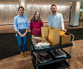 National Life Group employees with cart of meals to donate for community Thanksgiving